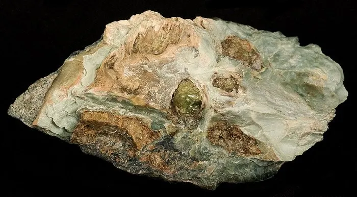 4 Crystals and Crystallization A grain of green olivine, surrounded by serpentine, from the Austrian Alps
