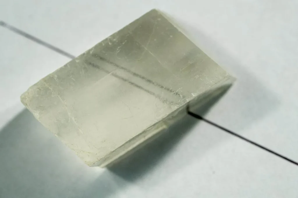 5 Optical Mineralogy Calcite displaying double refraction that shows two images of a line