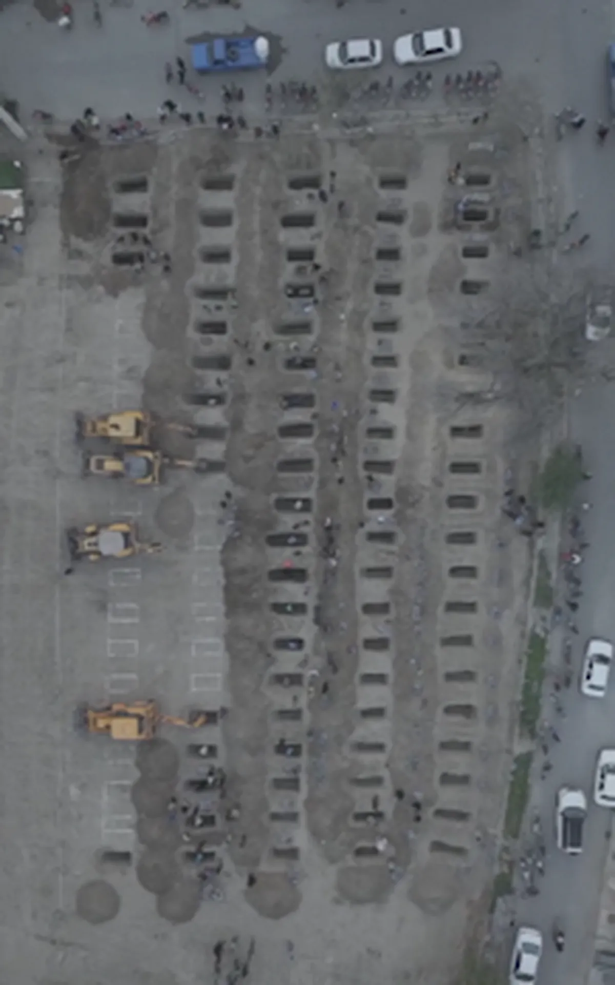 Watch: Drones stark view of graves readied for Iran school attack victims.