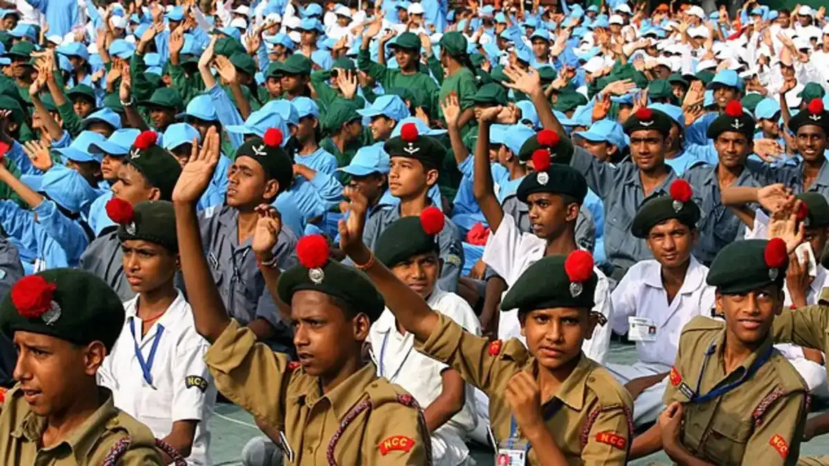 A diverse group of happy Delhi school students sitting in a modern, tech-enabled smart classroom.
