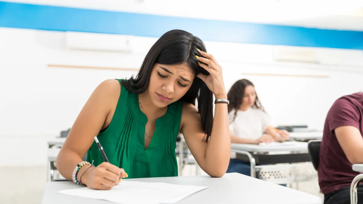 A student anxiously checking their revised MAH MCA CET 2026 admit card on a laptop after the last-minute exam center change announcement.