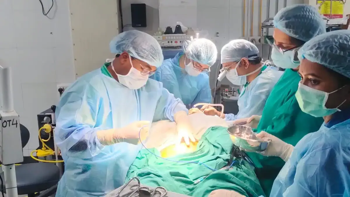 A dental student carefully studying a model of human teeth, representing the changes from the new National Dental Commission Act.