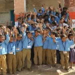 A bright, modern classroom in a newly reconstructed Rajasthan school filled with students engaged in learning.