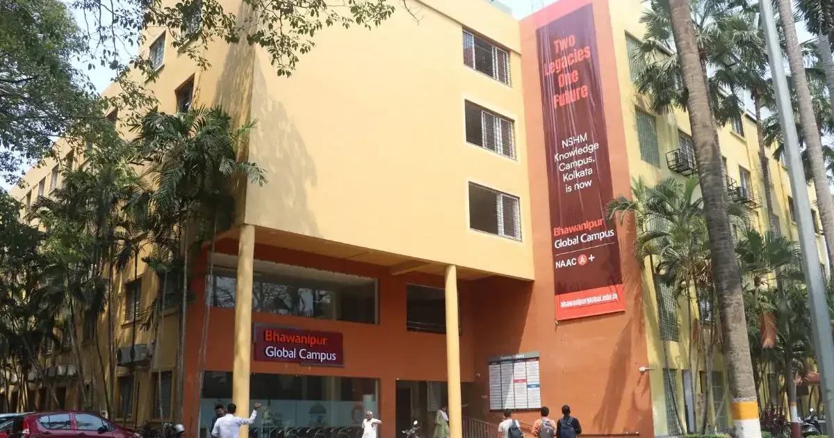 Front view of the newly launched Bhawanipur Global Campus building in Kolkata with students walking nearby.