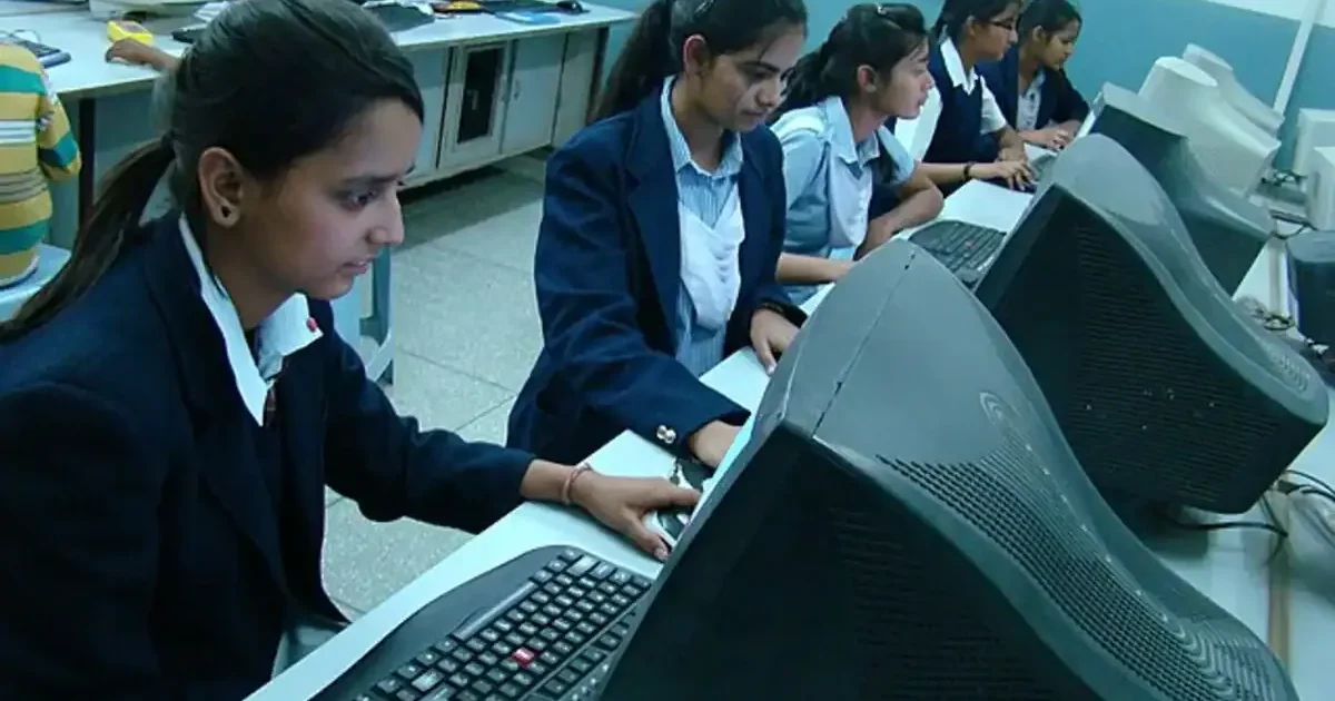 A student checks their RBSE Class 9 & 11 Result 2026 online on a laptop, looking relieved and happy with their scores.