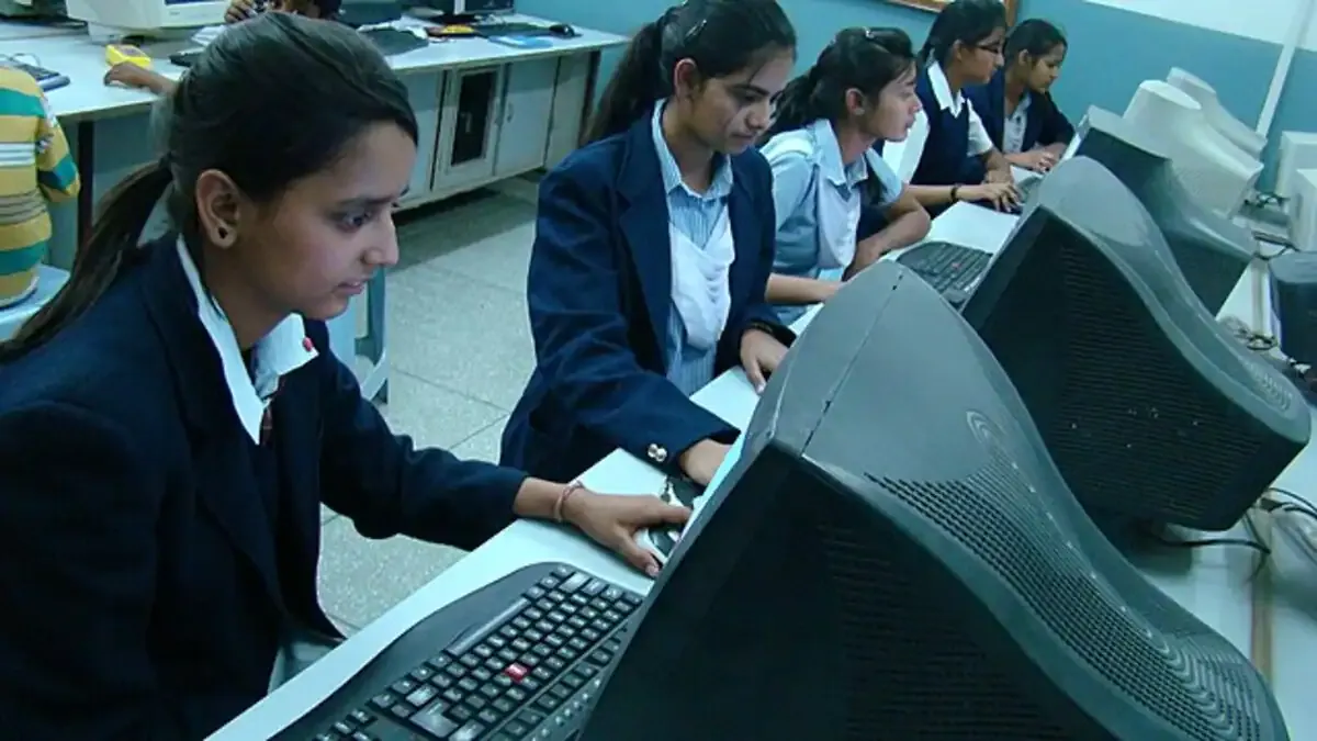 A student checks their RBSE Class 9 & 11 Result 2026 online on a laptop, looking relieved and happy with their scores.