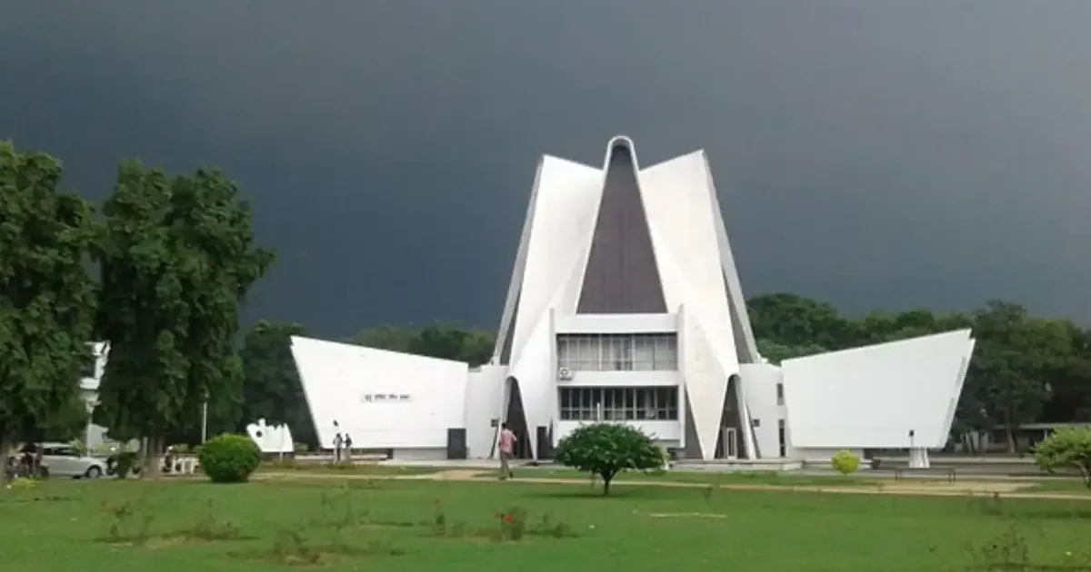 An aerial view of a university campus with modern academic buildings and lush green lawns, representing university budget allocation.