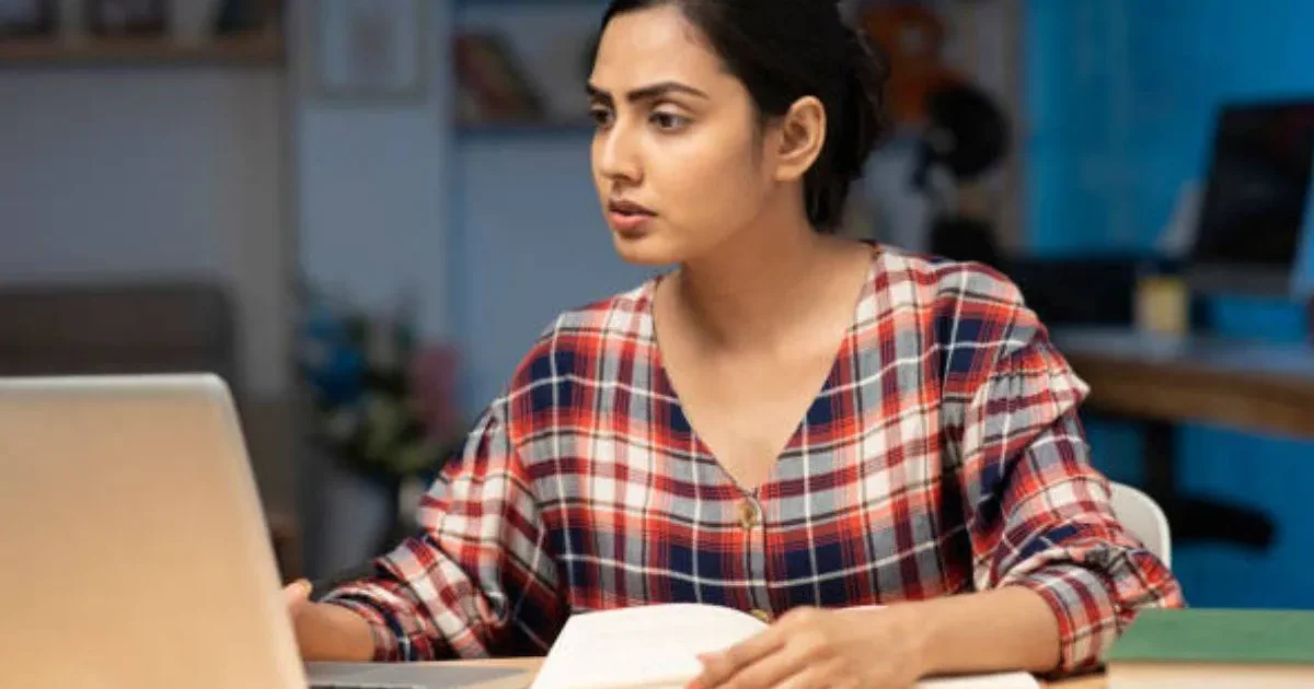 A student focused on their computer screen, preparing to download the official KEAM 2026 Admit Card from the CEE Kerala website.
