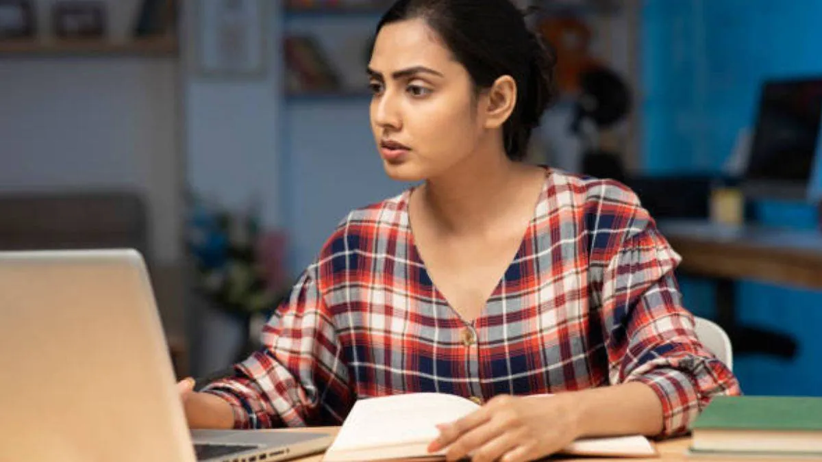 A student focused on their computer screen, preparing to download the official KEAM 2026 Admit Card from the CEE Kerala website.