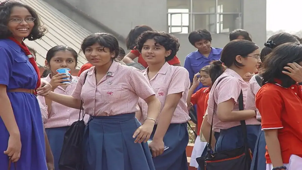 A student studying for the ISC Class 12 Economics board exam with textbooks, graphs, and a calculator on their desk.
