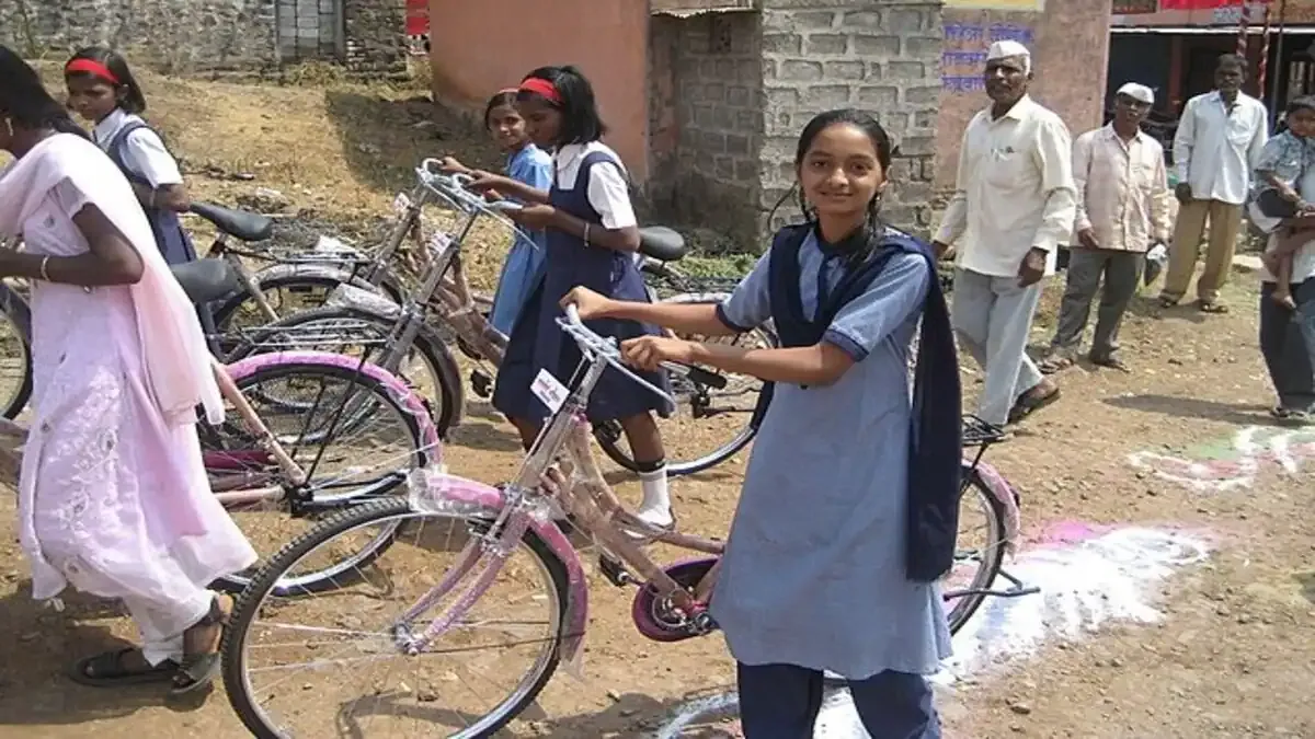 Delhi's New Plan for Girls is a Game-Changer A smiling girl student in her school uniform proudly stands with her new bicycle provided by the Delhi government initiative.