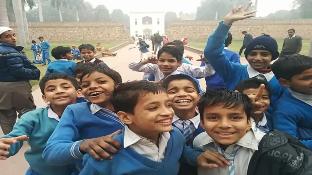 A student smiling while checking the JNVST Class 6 Result 2026 on a laptop screen with the StudyHub logo visible.