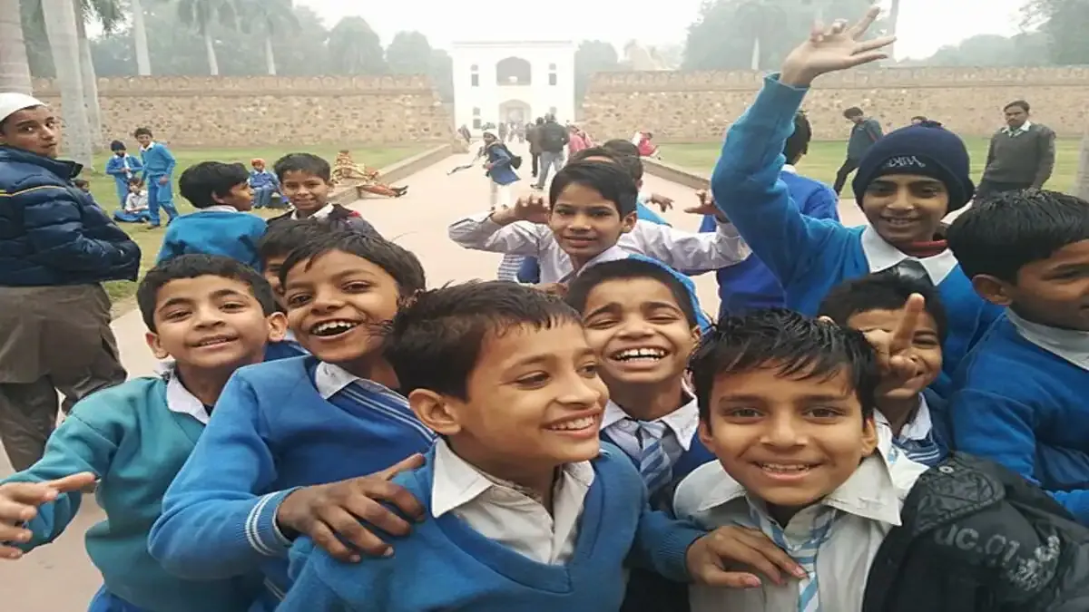 A student smiling while checking the JNVST Class 6 Result 2026 on a laptop screen with the StudyHub logo visible.