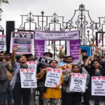Students protesting with banners outside a University of Delhi campus building during the controversial job mela.
