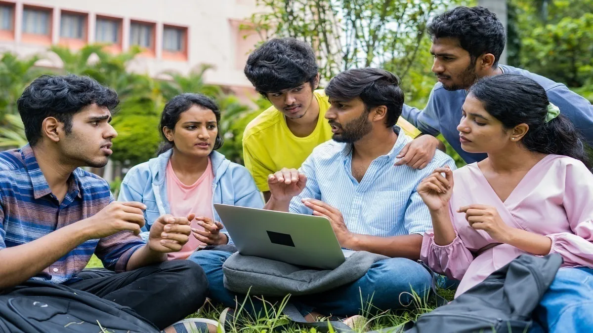 A student looking thoughtfully at a laptop screen displaying the IIT JAM 2026 counselling registration portal.