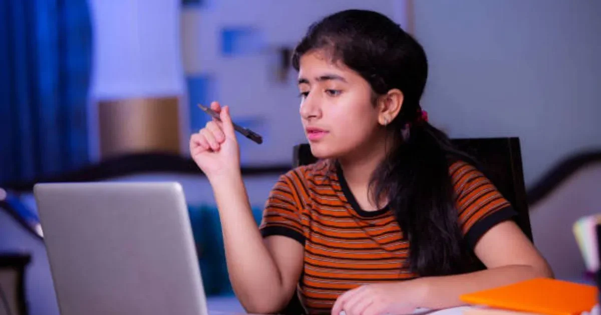 A concerned student looking at a laptop screen displaying the MHT CET 2026 login portal with an error message.