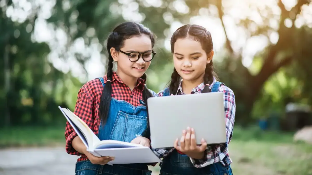 A young student smiling and raising their hand in a bright, modern Kendriya Vidyalaya classroom, ready for the 2024 admission process.