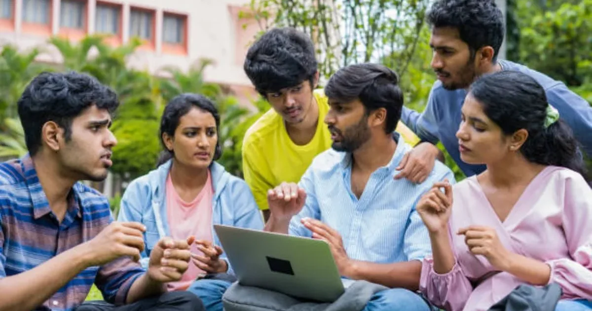 A student looking at their laptop screen for the BITSAT 2026 city slip, with a checklist graphic of common mistakes to avoid.