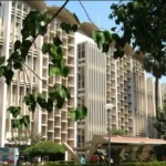 The iconic main building of IIT Bombay with a clear blue sky, representing the start of the 2026 postgraduate admission season.