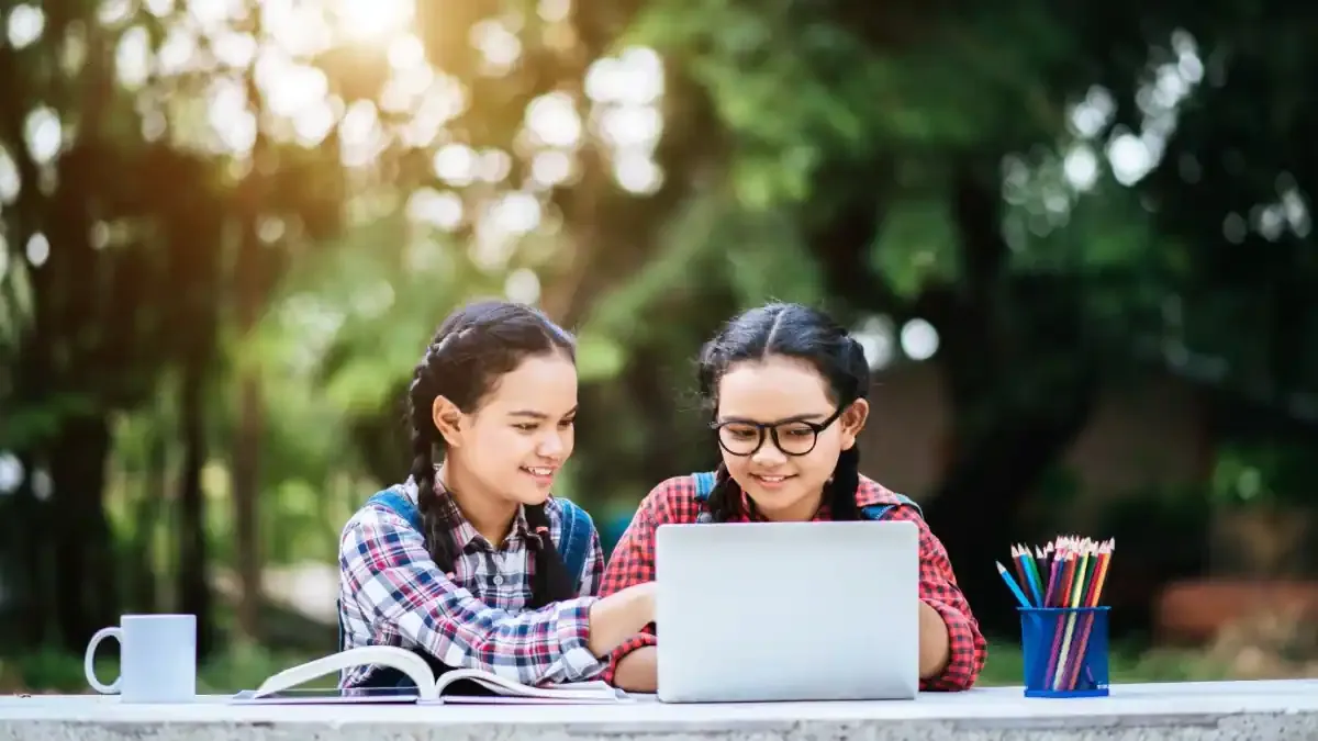 A student looking relieved and happy while checking the RBSE Result 2026 for Class 5 or 8 on a laptop screen displaying the official portal.