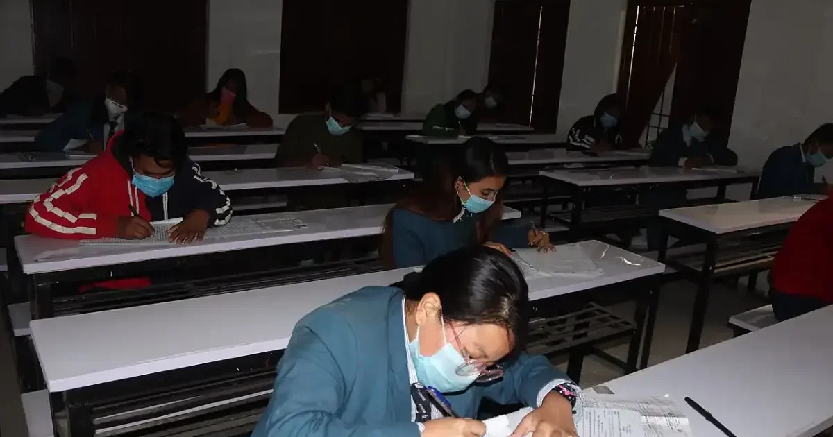 A student looking at their RBSE 10th Result 2026 on a laptop screen with a look of relief and happiness.