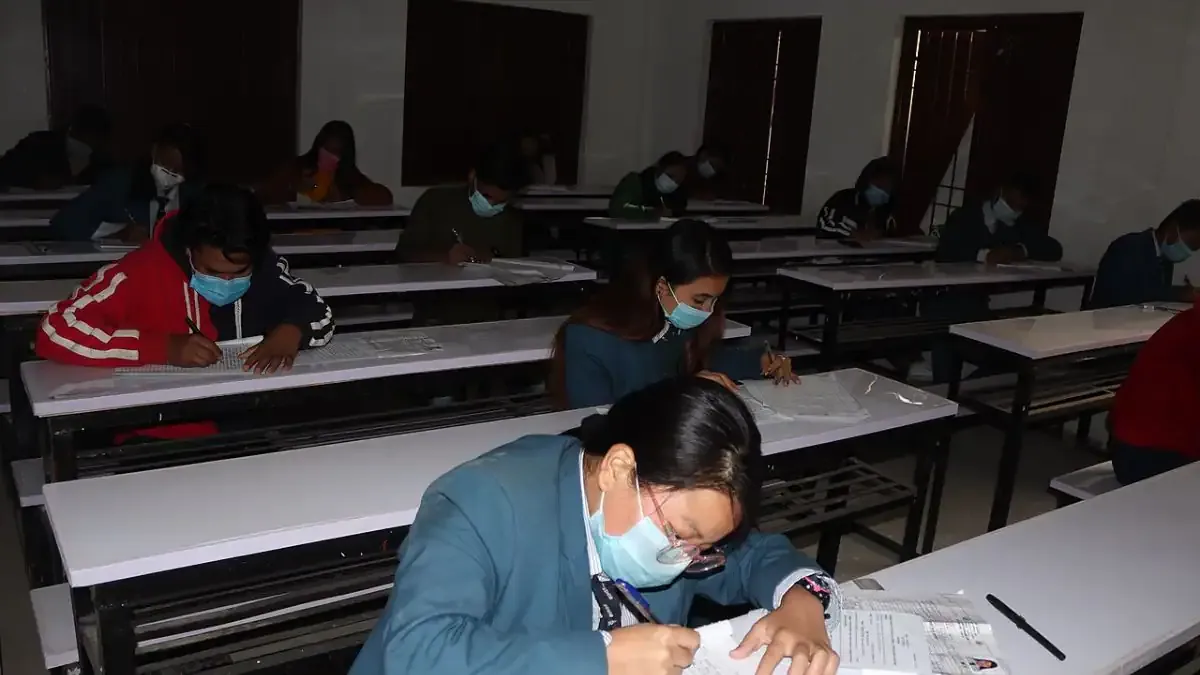 A student looking at their RBSE 10th Result 2026 on a laptop screen with a look of relief and happiness.