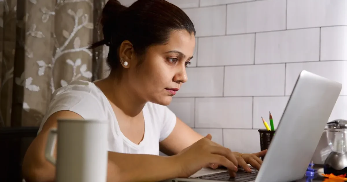 A nursing student in a blue uniform carefully preparing a syringe, representing the CG BSc Nursing 2026 application process.