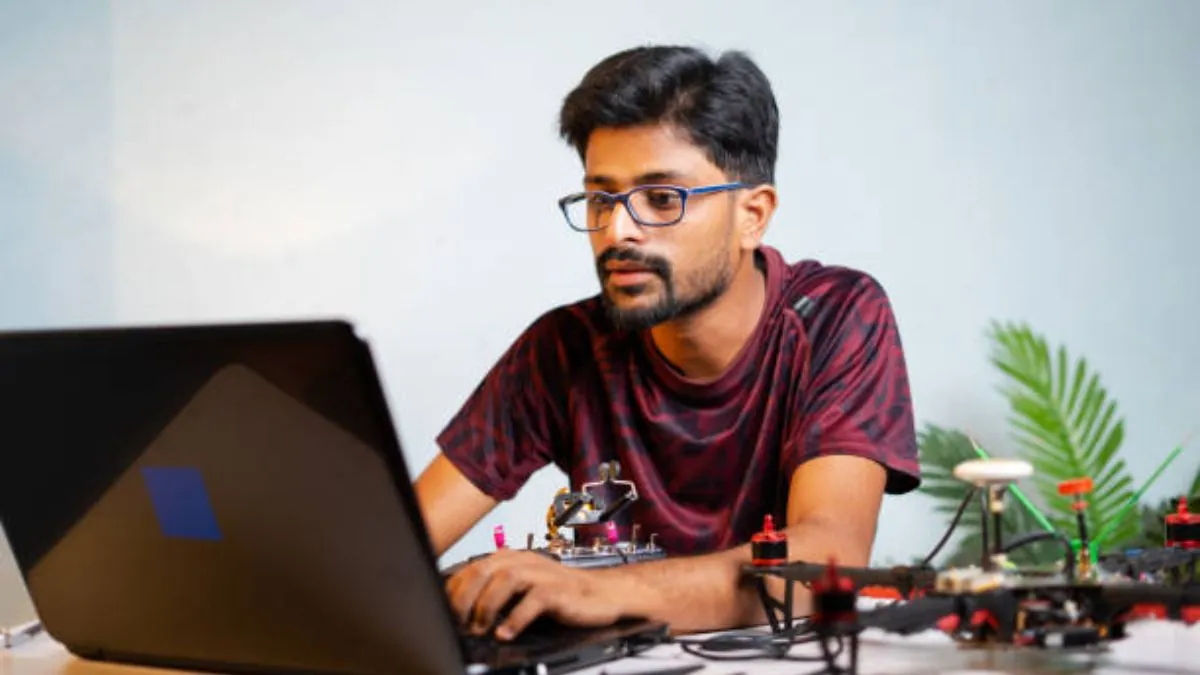 Anxious student checking their laptop for the MHT CET 2026 city intimation slip update on the StudyHub platform.