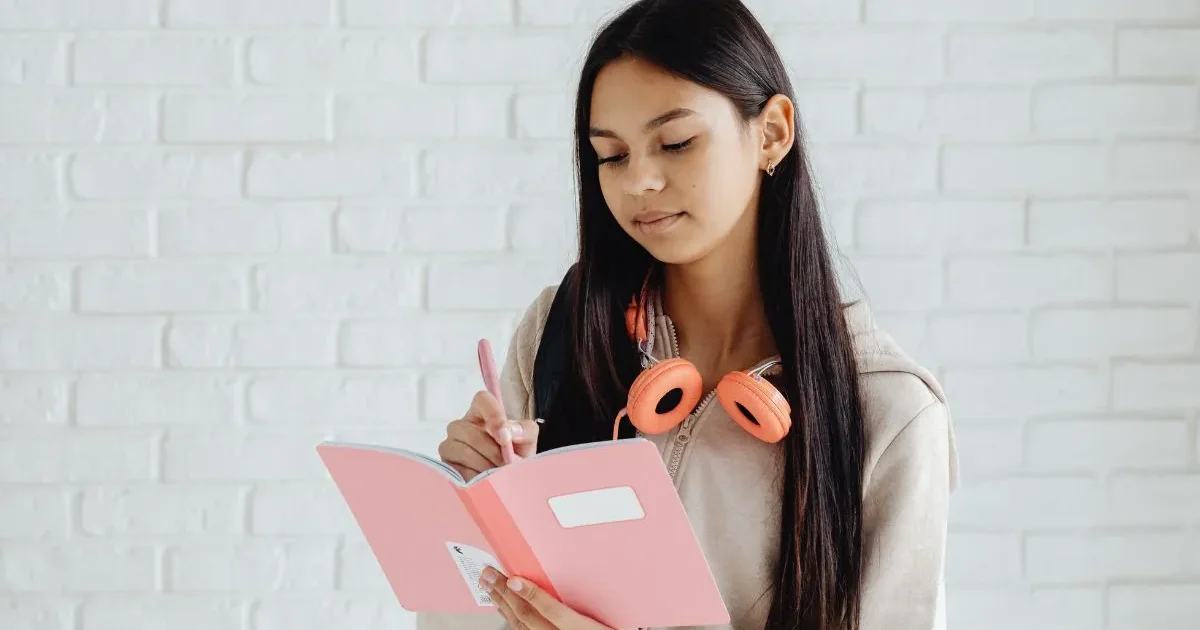 A focused student reviewing their JEE Main 2026 admit card and documents before entering the engineering entrance exam centre.