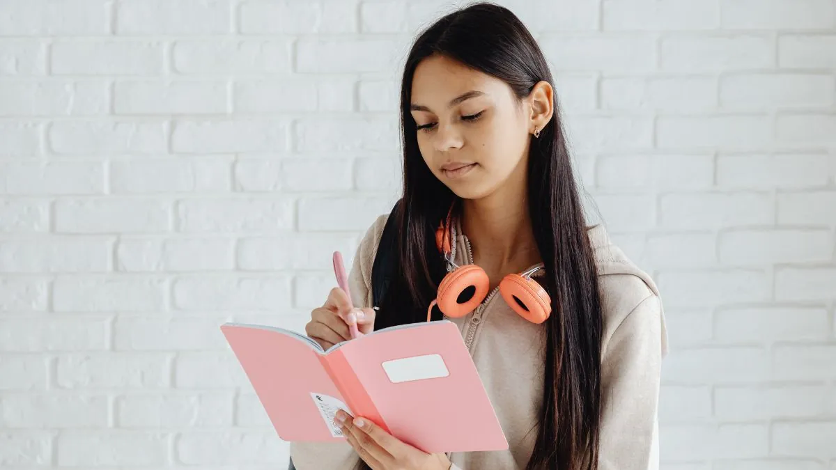 A focused student reviewing their JEE Main 2026 admit card and documents before entering the engineering entrance exam centre.